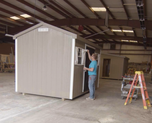 Valley Structures employee painting a shed in the Dayton shop