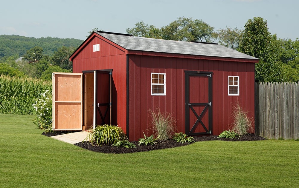 red cottage style shed on grass