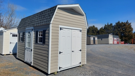 beige shed used as storage unit sitting on sales lot.