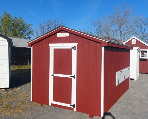 red chicken coop with white trim