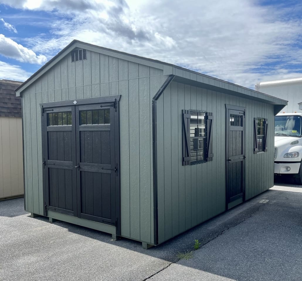Carriage House Shed Cost-effective sturdy green shed used for storage.