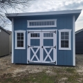 Shed with blue siding, white trim and 3 windows