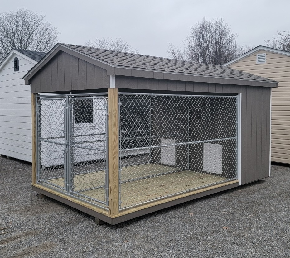 Dog kennel with two dog boxes and two dog runs with tan siding.